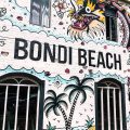 Colorful mural art graces a wall at iconic Bondi Beach in Sydney, showcasing urban creativity.