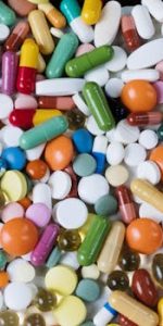 pexels-photo-5723612-5723612 Vibrant assortment of medicine capsules and tablets in a flatlay format, highlighting diversity in pharmaceuticals.